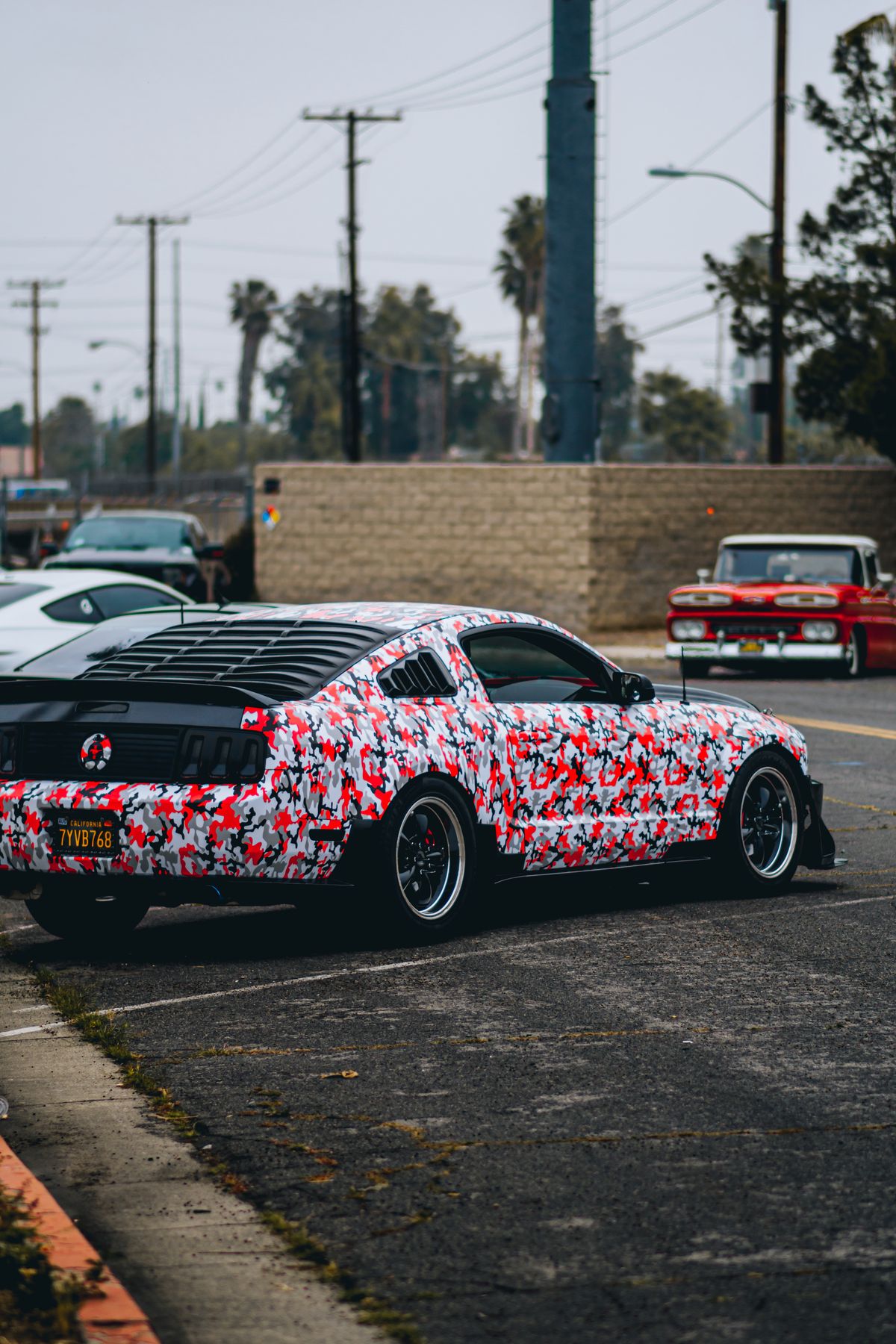 Coupe with a red, white, and black patterned wrap