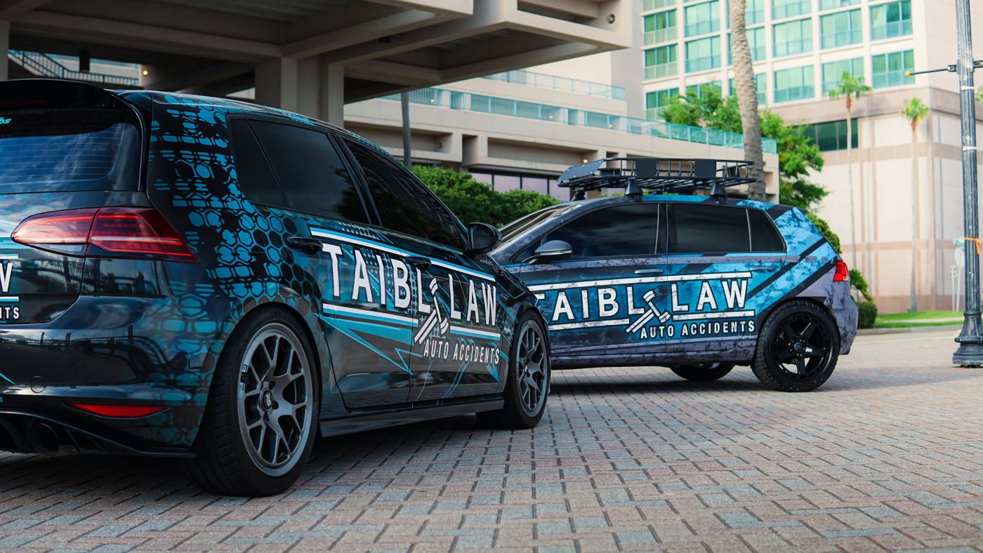 Two branded company vehicles with coordinated blue commercial wraps