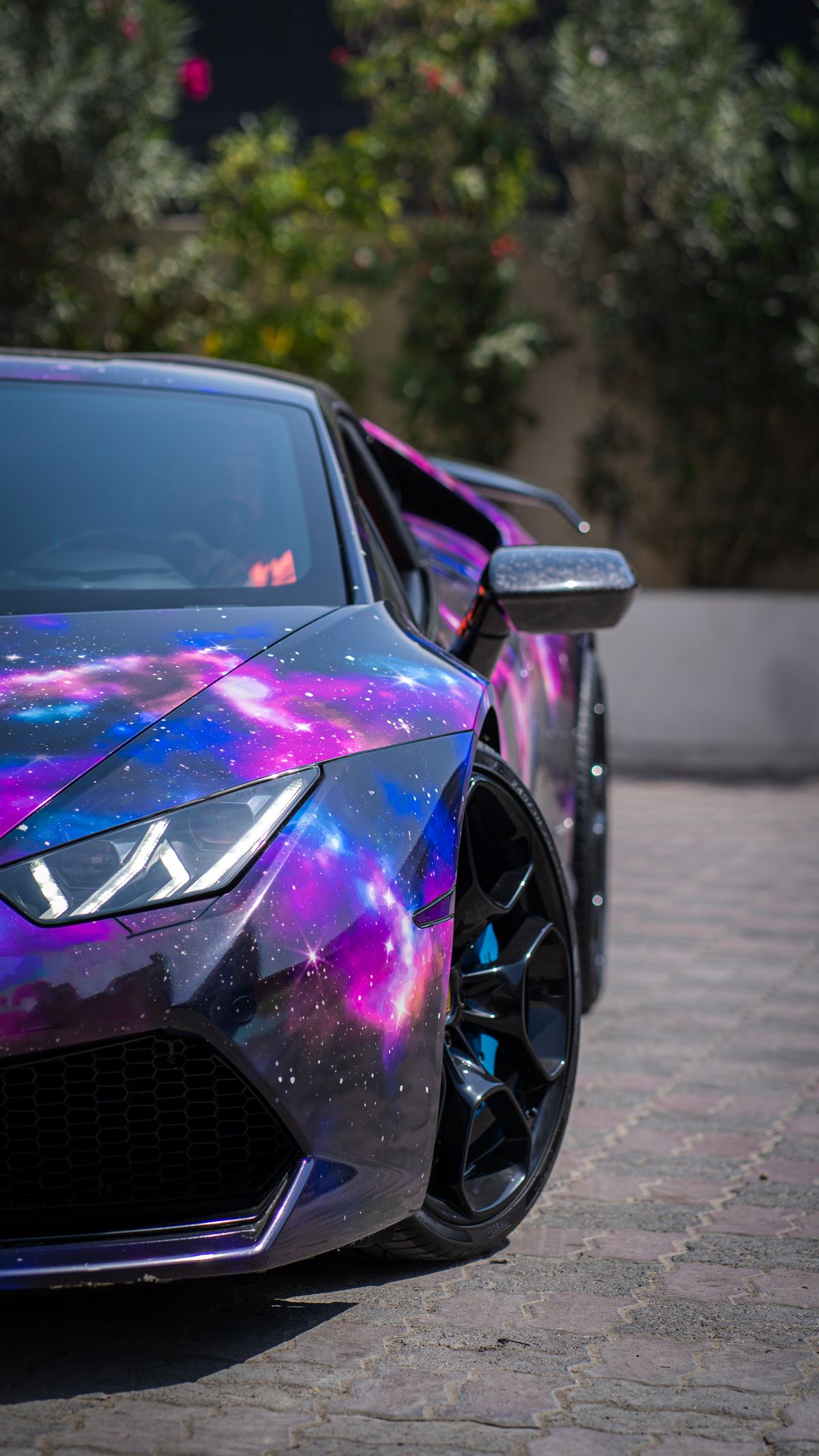 Lamborghini with a purple and blue galaxy wrap
