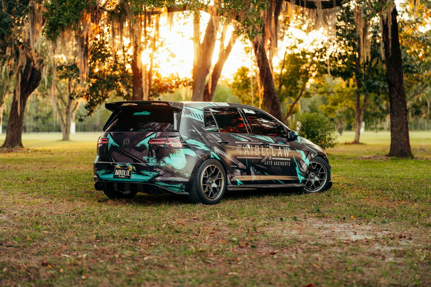 Custom-wrapped hatchback photographed at sunset