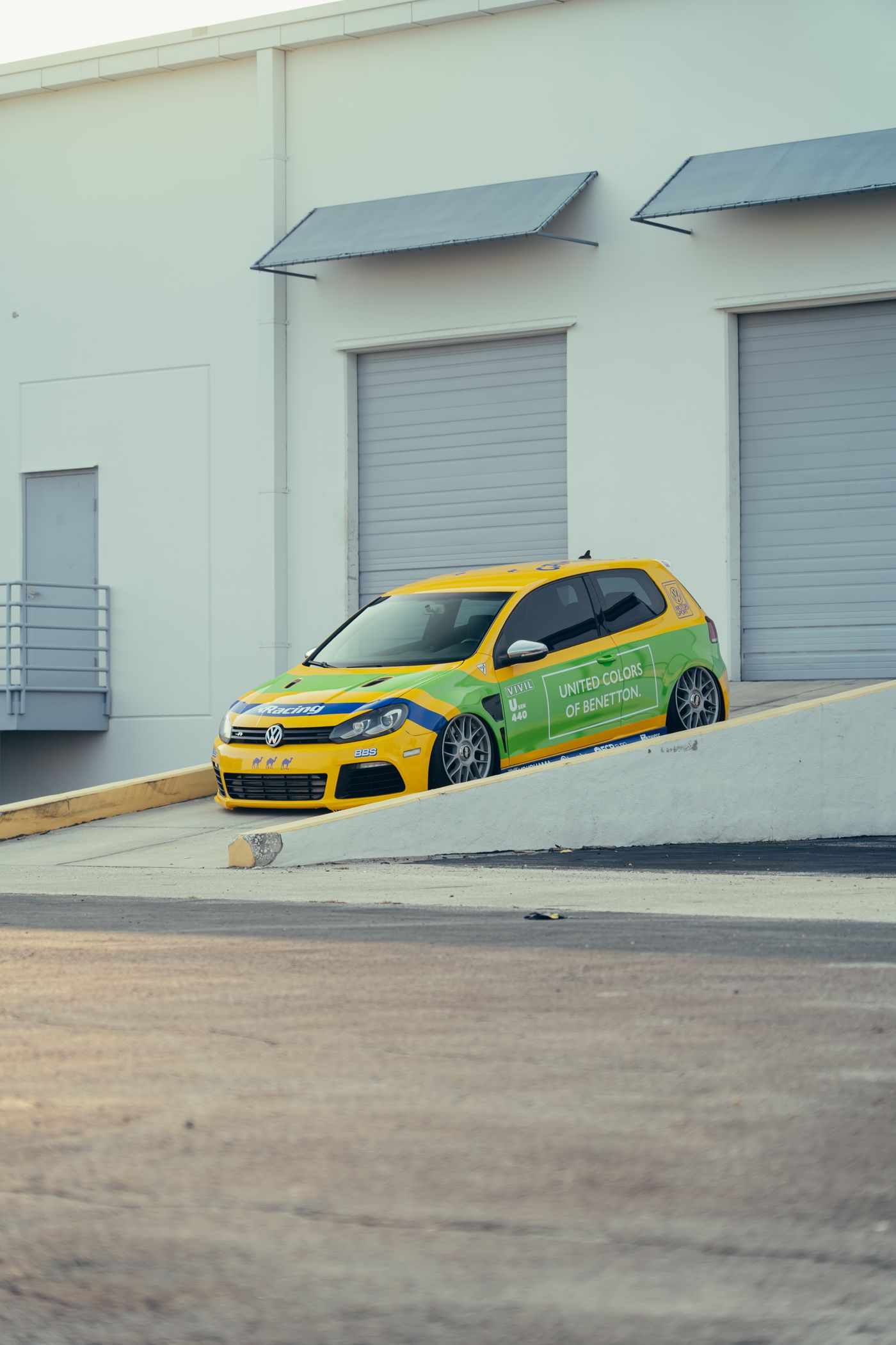 Volkswagen with green and yellow racing graphics